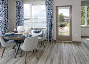 Thumbnail 5 of 30 - A dining room with a table and a view of the water.