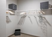 Thumbnail 9 of 30 - A row of clothes hangers on a clothes rail.