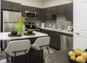 Thumbnail 5 of 25 - a kitchen with stainless steel appliances and an island with chairs
