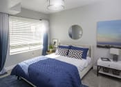 Thumbnail 6 of 25 - a blue and white bedroom with a bed and a window