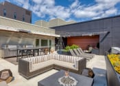 Thumbnail 10 of 30 - a patio with couches and tables and a fire pit