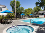 Thumbnail 11 of 13 - Apartments For Rent In Livermore, CA - Autumn Springs - Pool With Hot Tub, Tables, Chairs, Umbrellas, And Lounge Chairs