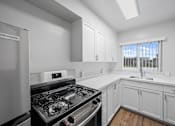 Thumbnail 29 of 55 - A kitchen with a fridge and a stove at Hillsdale Garden Apartments, CA 94403
