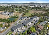 Thumbnail 48 of 50 - A bird's eye view of a residential area with houses and a road.