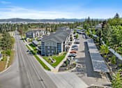 Thumbnail 46 of 50 - A road with a parking lot and houses on the side.