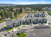 Thumbnail 45 of 50 - A large building complex with a parking lot in front.