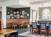 Thumbnail 11 of 41 - A dining room with a wooden table and chairs.