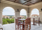 Thumbnail 15 of 41 - A patio with a table and chairs overlooking a fence.
