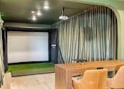 Thumbnail 24 of 41 - A room with a desk and chairs and a projection screen.
