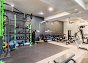 Thumbnail 17 of 41 - A well-equipped gym with various fitness machines and weights.