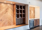 Thumbnail 21 of 41 - A wooden cabinet with glass doors is open, revealing a kitchen appliance inside.