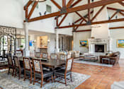 Thumbnail 35 of 41 - A large room with a fireplace and a dining table.