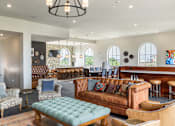 Thumbnail 12 of 41 - A large room with a couch, chairs, and a table.