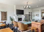 Thumbnail 14 of 41 - A living room with a fireplace and a tv.
