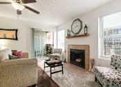 Thumbnail 10 of 21 - A living room with a fireplace and a couch.