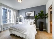 Thumbnail 11 of 37 - a bedroom with a large bed and a large window