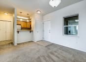 Thumbnail 13 of 37 - a bedroom with a large window and a door leading to a kitchen
