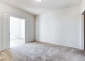 Thumbnail 15 of 37 - a bedroom with white walls and carpet