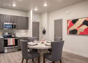 Thumbnail 1 of 29 - Modern kitchen with a dining table set for two.