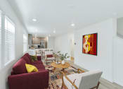 Thumbnail 39 of 51 - a living room with a red couch and a table