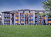 Thumbnail 21 of 27 - A large apartment complex with multiple balconies and staircases.