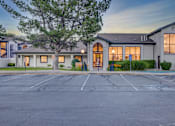 Thumbnail 12 of 27 - A building with a parking lot in front of it.