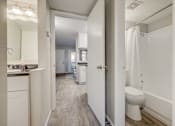 Thumbnail 10 of 27 - A white bathroom with a toilet and a shower.