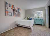 Thumbnail 7 of 27 - A bedroom with a bed, dresser, and a painting on the wall.