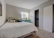 Thumbnail 8 of 27 - A bedroom with a large bed and a painting on the wall.