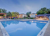 Thumbnail 24 of 27 - A large swimming pool with a reflection of the sky and trees.