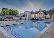 Thumbnail 26 of 27 - A large house with a pool in front.