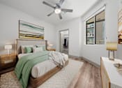 Thumbnail 5 of 31 - A bedroom with a large bed and a ceiling fan.