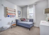 Thumbnail 11 of 33 - a bedroom with a bed and a desk and a window