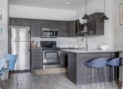 Thumbnail 1 of 33 - a kitchen with stainless steel appliances and a counter