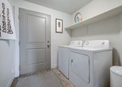 Thumbnail 14 of 33 - a washer and dryer in a laundry room with a door