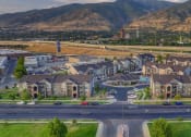 Thumbnail 30 of 33 - an aerial view of a neighborhood of houses with mountains in the background