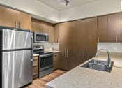 Thumbnail 12 of 30 - a kitchen with wooden cabinets and stainless steel appliances at Allez, Washington, 98052