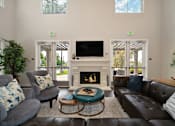 Thumbnail 9 of 31 - A living room with a fireplace and a flat screen TV.