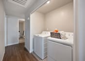 Thumbnail 29 of 31 - A laundry room with a washer and dryer.