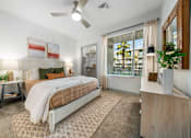 Thumbnail 7 of 34 - A bedroom with a bed, nightstand, and a plant on the side table.