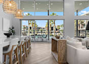 Thumbnail 13 of 34 - A modern living room with a dining area and a view of the outdoors.
