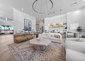 Thumbnail 14 of 34 - A modern living room with a white sofa set and a wooden coffee table.
