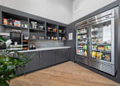 Thumbnail 15 of 34 - A modern kitchen with a refrigerator, shelves, and a plant.