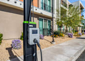 Thumbnail 31 of 34 - A Blink charging station is installed on a sidewalk in front of a building.
