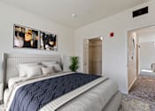 Thumbnail 8 of 36 - A bedroom with a large bed and a carpeted floor.