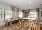 Thumbnail 17 of 23 - a kitchen with a bar and a table with chairs
