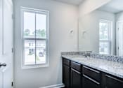 Thumbnail 29 of 30 - Primary bathroom with long countertop