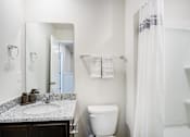 Thumbnail 19 of 30 - Full bathroom with built in shower shelving