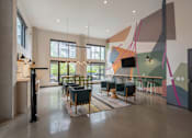 Thumbnail 29 of 34 - A modern room with a long table and chairs.