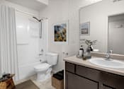 Thumbnail 4 of 29 - A bathroom with a white toilet and sink.